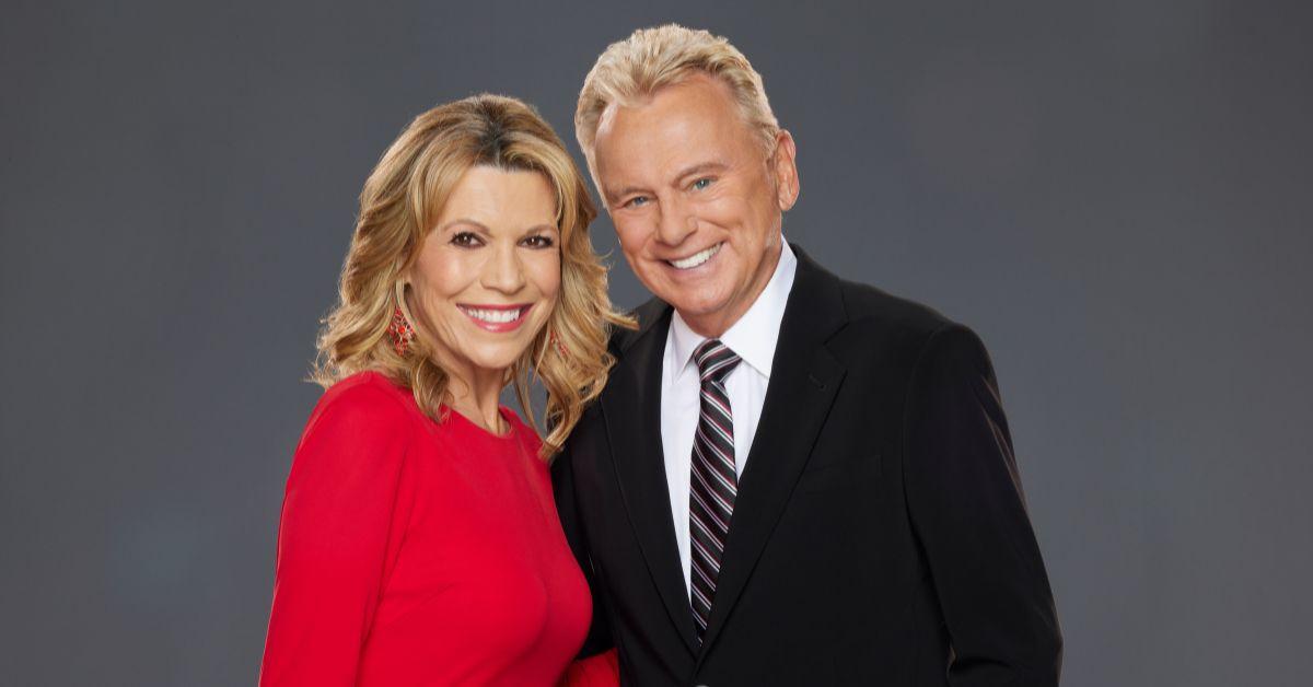 (l-r): Vanna White and Pat Sajak smiling together.