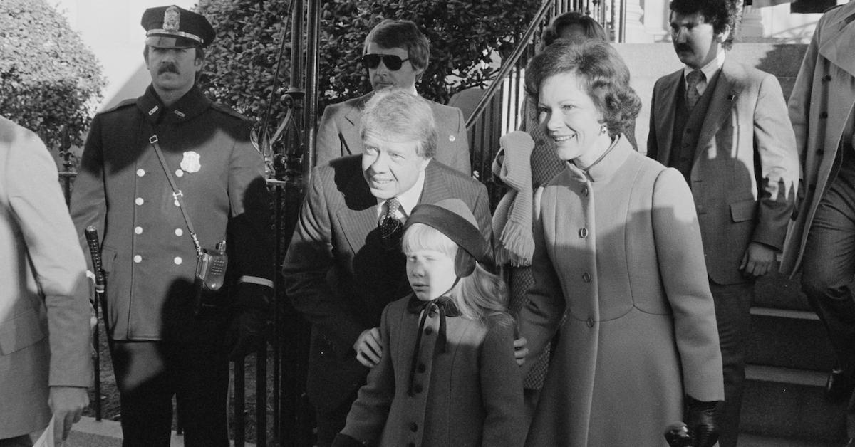 Jimmy Carter, First Lady Rosalynn Carter, and daughter Amy stand together on their way to ceremonies on Inauguration Day, Washington, DC, January 20, 1977