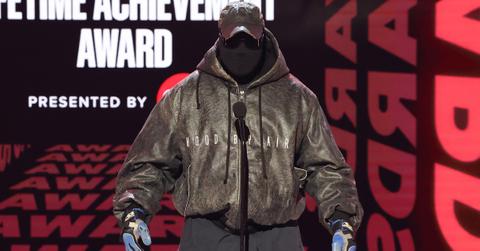 Kanye West wearing a mask speaking at the 2022 BET Awards.