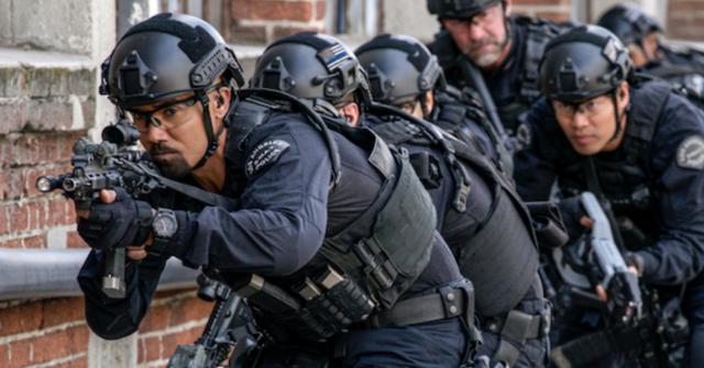 'S.W.A.T' officers entering a building to get the bad guys.