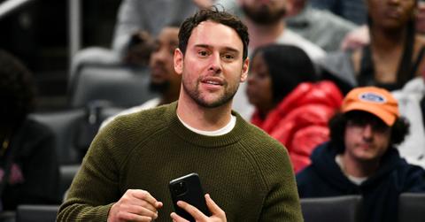 Scooter Braun wearing a green sweater, attending a Los Angeles Clippers basketball game