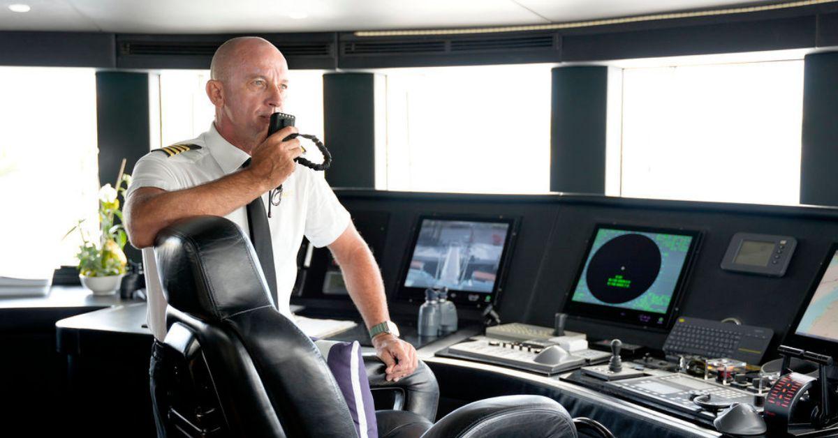 Captain Kerry speaking into handheld speaker aboard the super yacht on 'Below Deck' Season 11