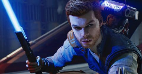 Star Wars Jedi: Survivor Cal Kestis drawing his blue lightsaber to fight.