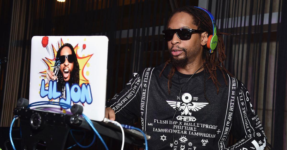 Lil Jon DJing an event and looking at his laptop.