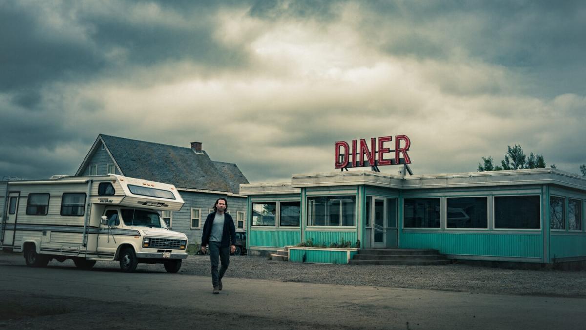 Jim standing outside of the diner on 'From'