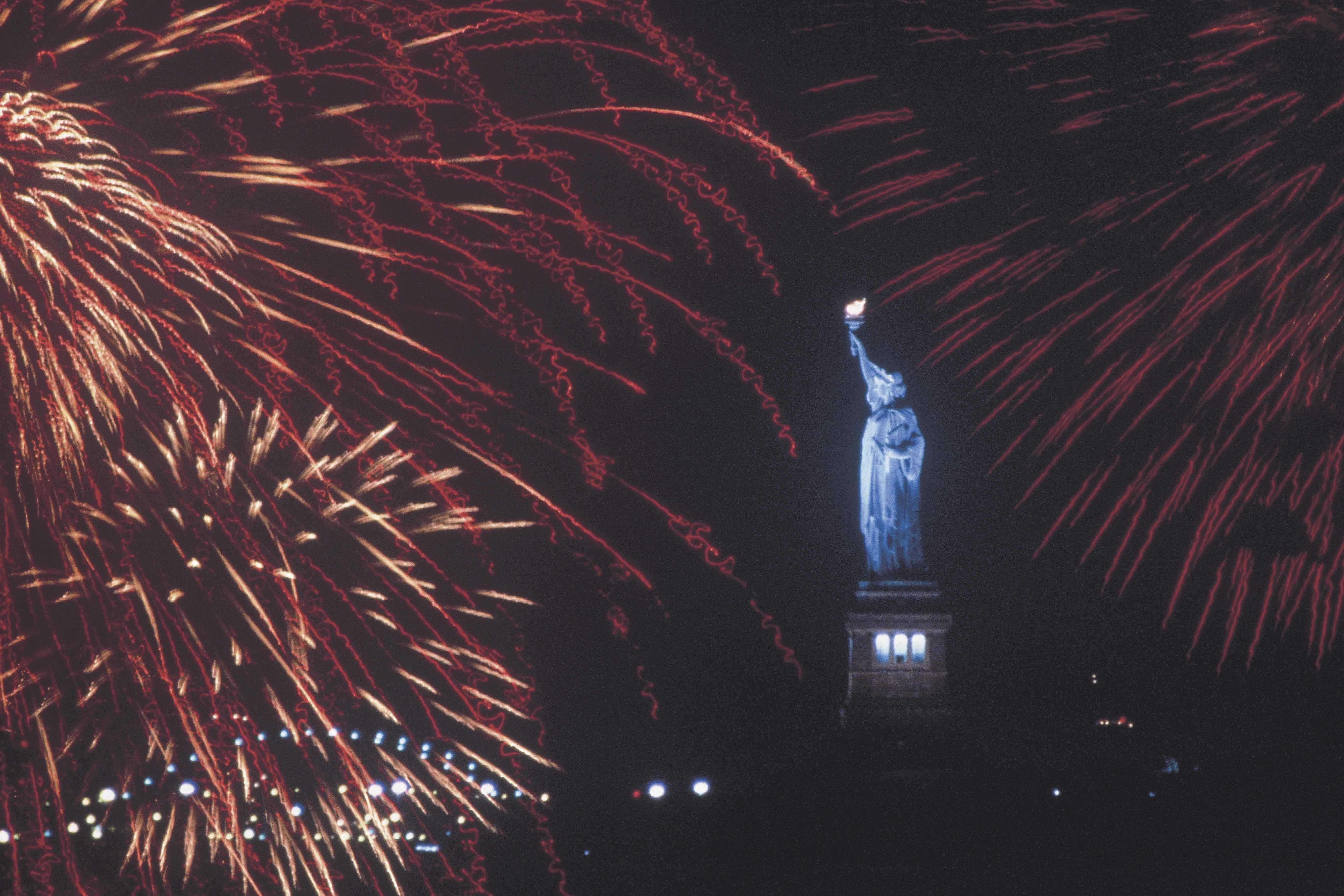 Statue of Liberty amidst a fireworks display.