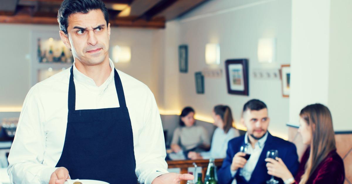 waiter dissatisfied with small tip from cafe visitors picture id