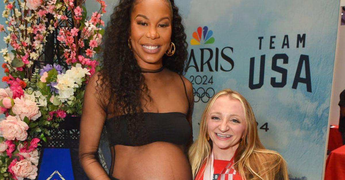 Sanya richards ross and fan pose for photo at BravoCon
