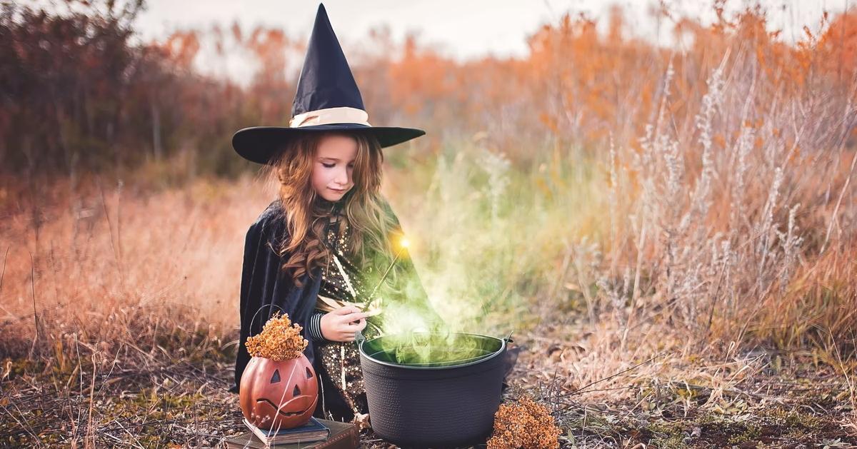 A little girl in a witch costume