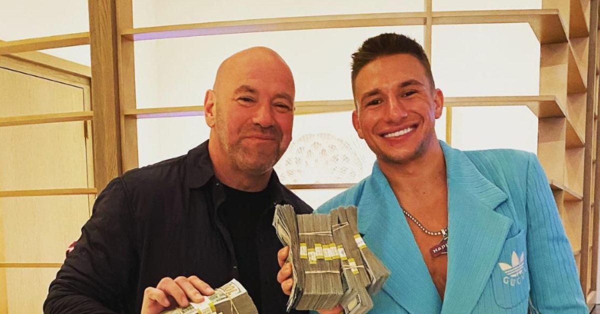 SteveWillDoIt holding stacks of money with Dana White.