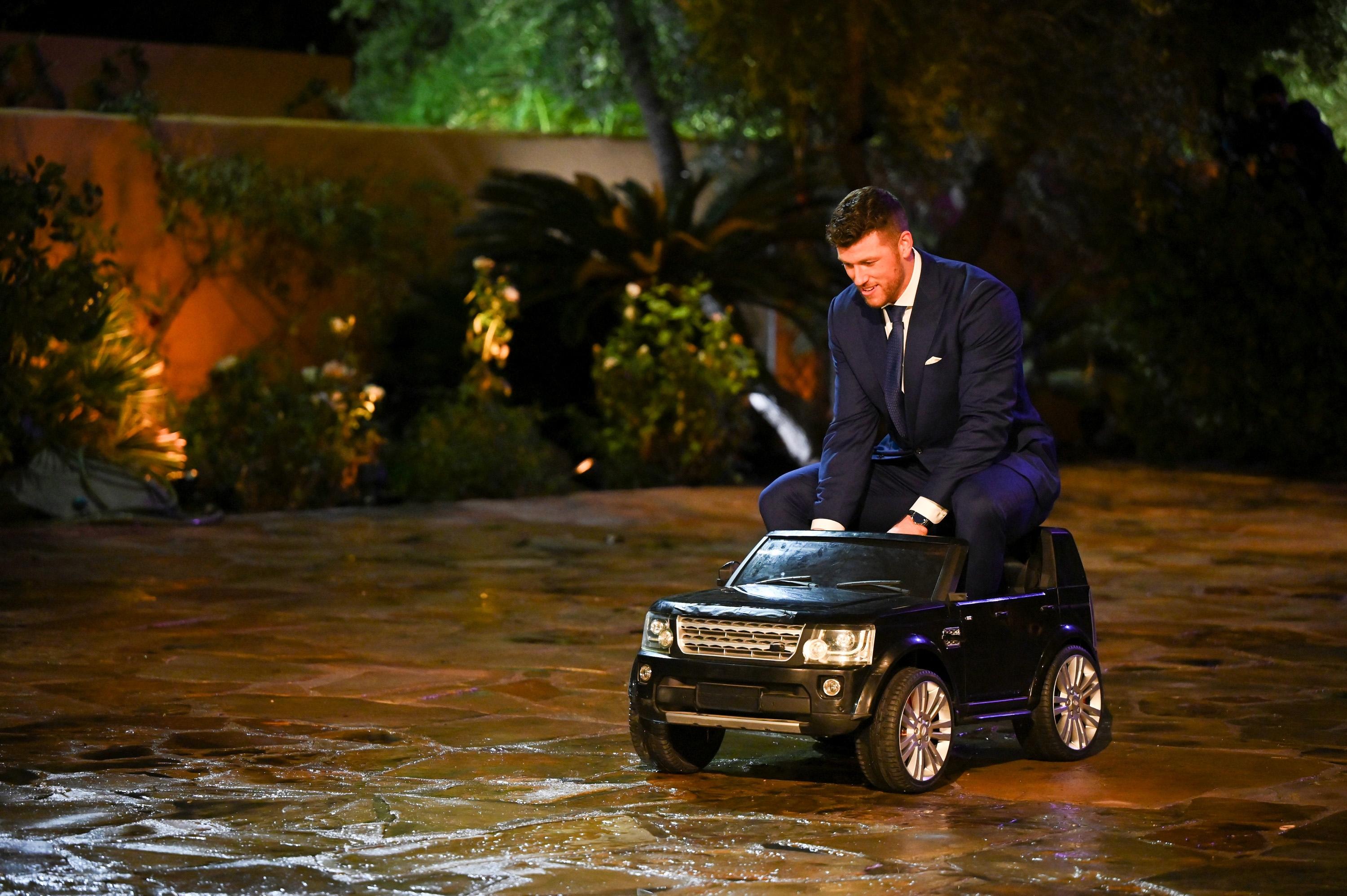 Clayton playing around on a toy car during the premiere of 'The Bachelor' Season 26.