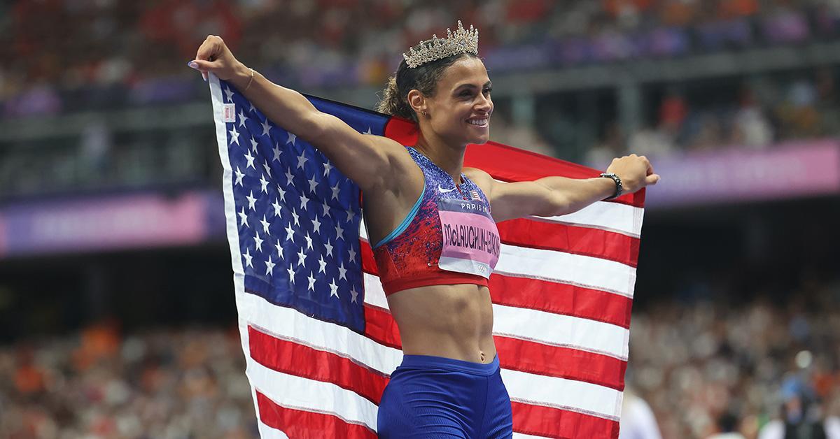 Sydney McLaughlin-Levrone holding a flag after the Paris Olympics 400m hurdles. 