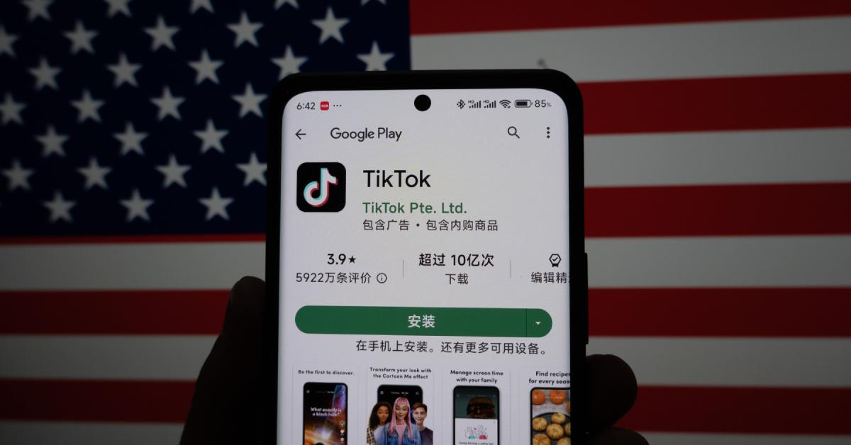 The TikTok app on a smartphone with an American flag in the background