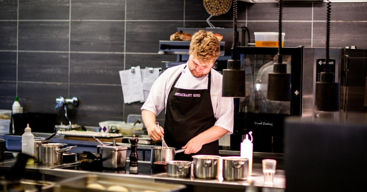 A chef working in a restaurant kitchen.