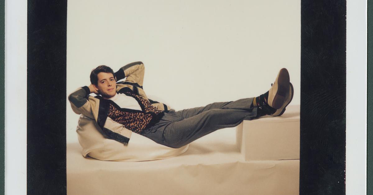 matthew broderick as ferris bueller reclining in chair with hands behind head