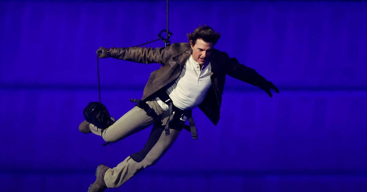 Tom Cruise jumps from the roof of the Stade de France during the Closing Ceremony 