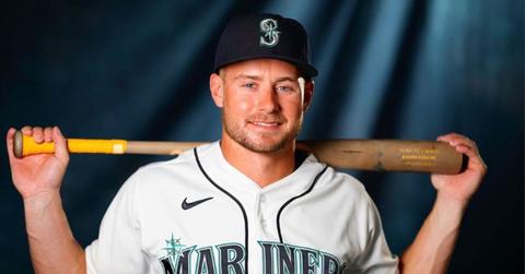 Jarred Kelenic holding a bat and wearing a Mariners jersey