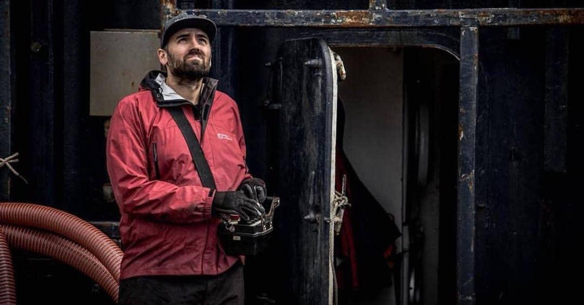 Zack Larson, Wild Bill's son, on his boat, wearing a red jacket