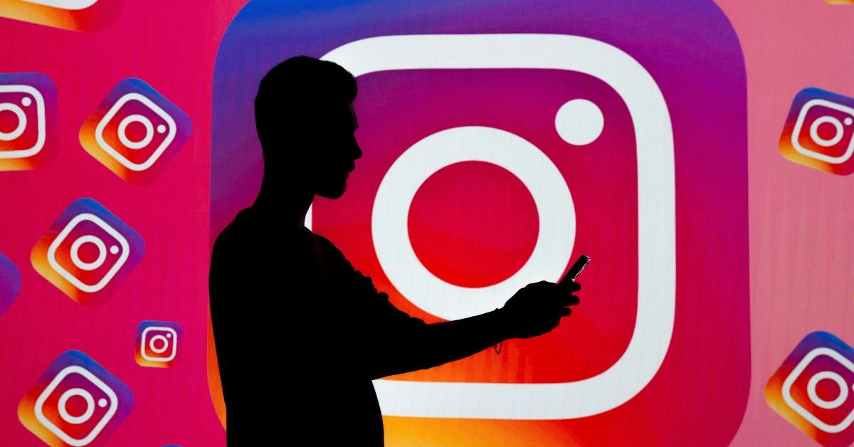  In this photo illustration, logo of 'Instagram' is displayed on a wide screen 