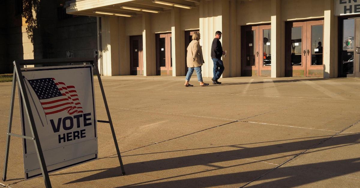 Two people walking into a polling station for Election Day.