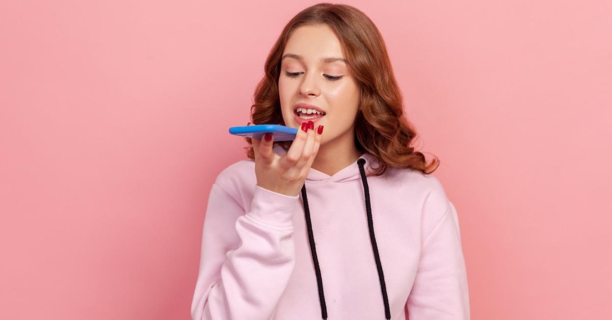 A Teen talking to an A.I. virtual assistant on her phone