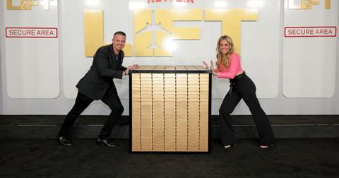 Nate and Danielle push on the opposite sides of a large box during a Netflix film event