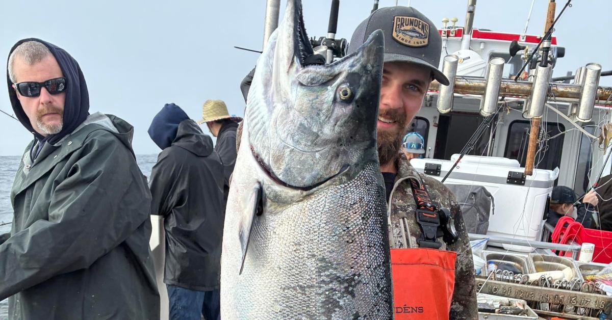 Todd Meadows holds up a fish he caught while out on a boat.