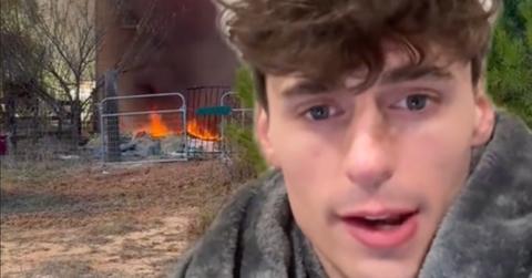 Noah Glenn Carter talking with an image of his house burning in the background