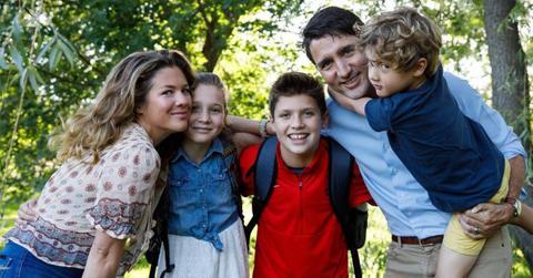 Sophie Trudeau, Ella-Grace Trudeau, Xavier Trudeau, and Haidrien Trudeau pose for back to school photo in front of trees.