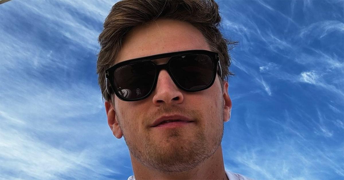 Logan Sargeant takes a selfie in sunglasses against the sky. 