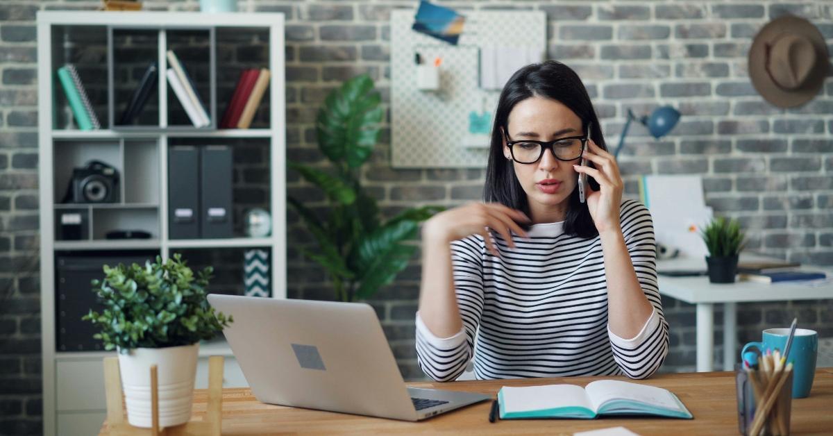 Annoyed woman sits at a laptop