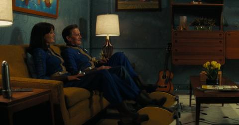 Lucy and her dad sitting on the couch in a vault in 'Fallout'