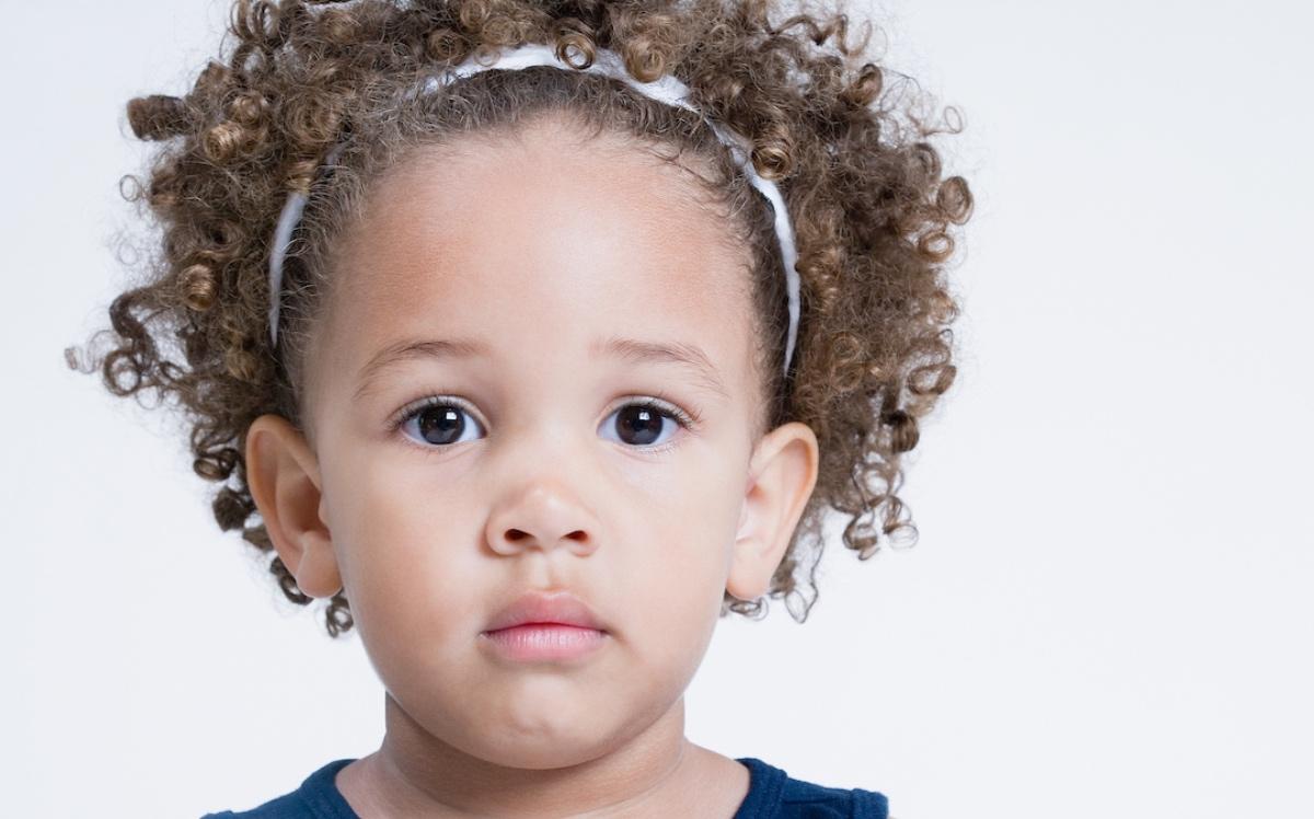 A cute toddler with curly hair