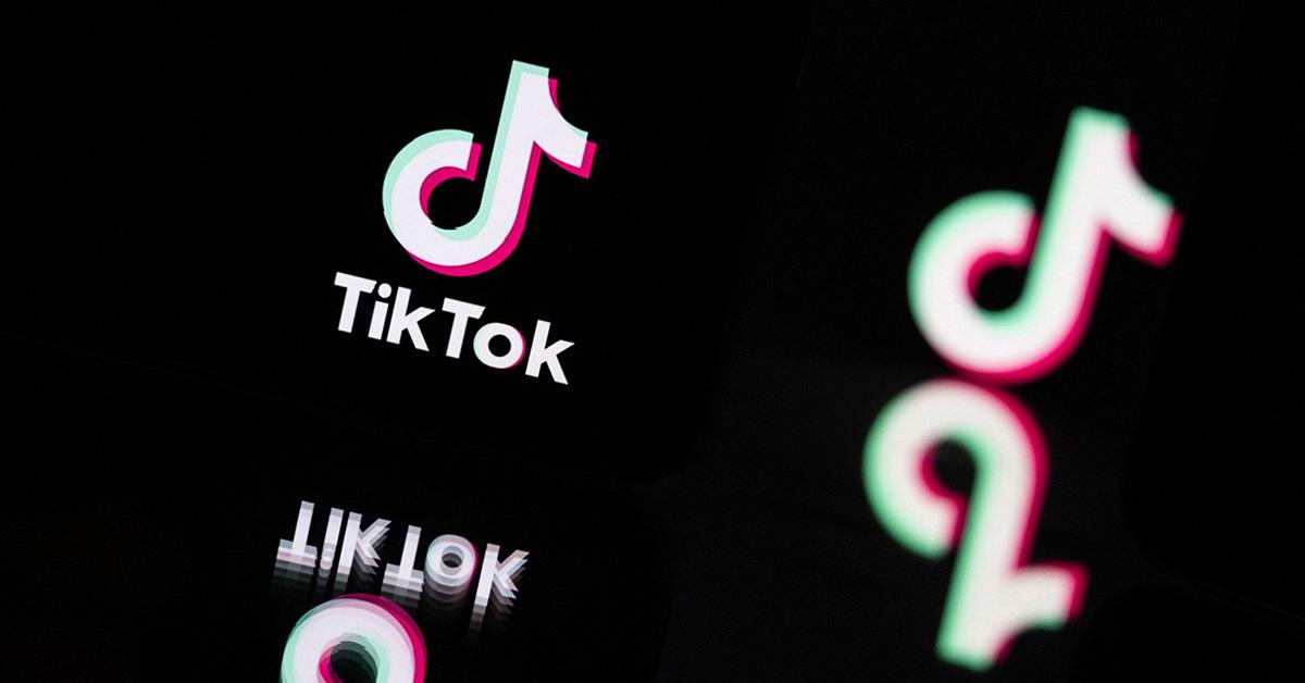 TikTok logo on a phone with a black background. 