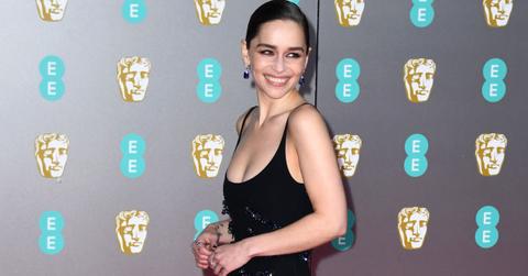 Emilia Clarke attending a red carpet event in a black sequined dress.