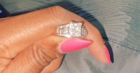 A woman holding a diamond dust ring