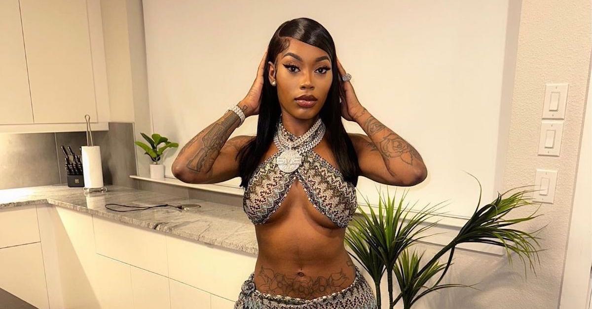 Asian Doll posing in a two piece in a kitchen