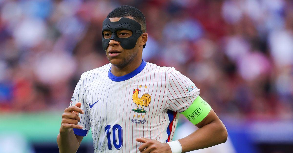 Kylian Mbappe, wearing a protective face mask, warms up ahead of the UEFA Euro 2024 round of 16 football match between France and Belgium