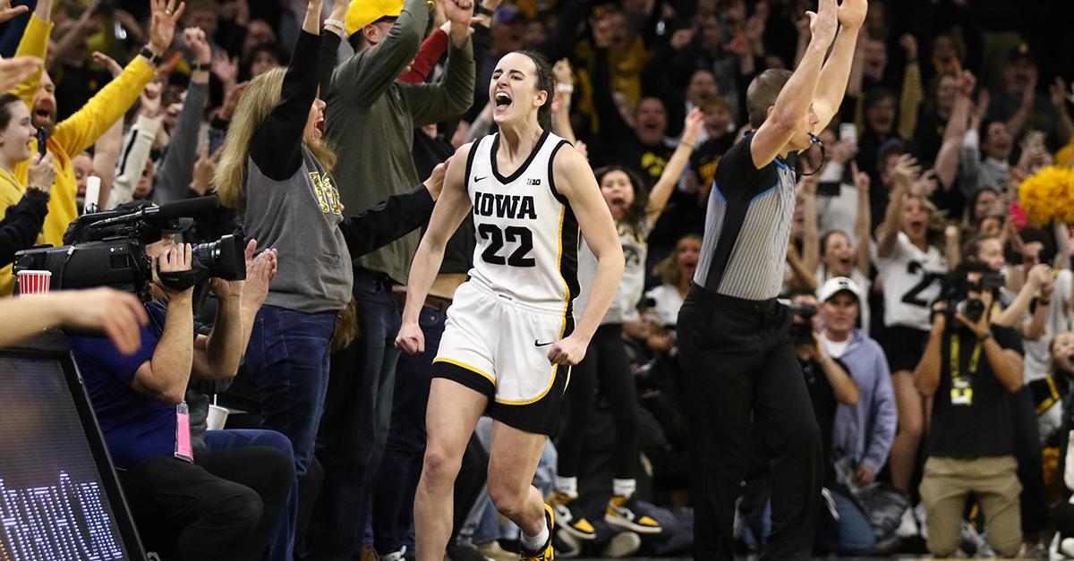 Caitlin Clark celebrates after breaking the NCAA women's all-time scoring record during the Iowa vs. Michigan game on Feb. 15, 2024 