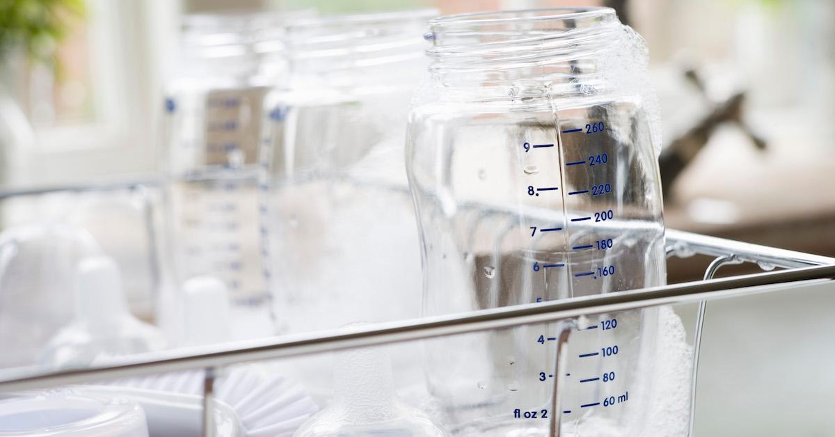 Clean baby bottles in a dish drying rack