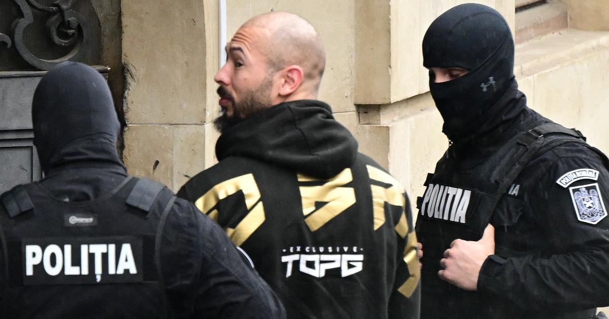 Andrew Tate (C) is led by police officers into the Court of Appeal building in Bucharest, Romania on March 12, 2024