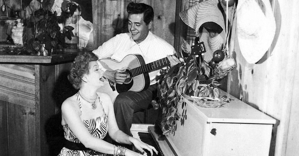 Desi Arnaz plays guitar while Lucille Ball plays piano