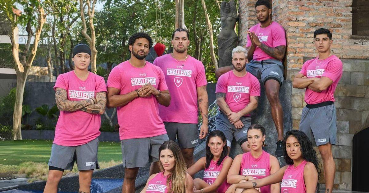 'The Challenge 40: Battle of the Eras' Pink team pose for a photo together, with Kyland and Josh whose hair is in braids, at center.