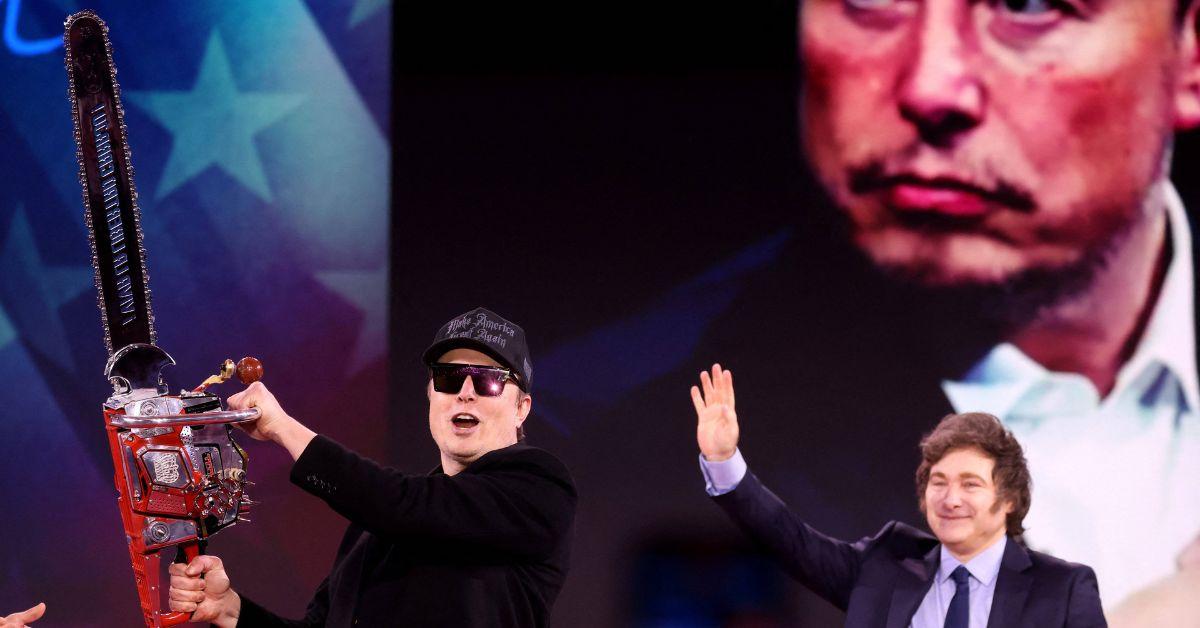 Elon Musk wielding a chainsaw on stage with Javier Milei. 