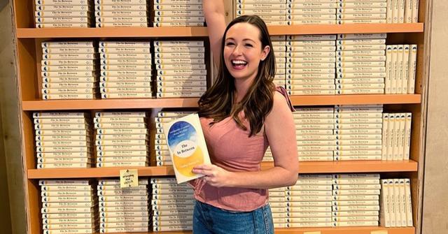 Hadley Vlahos holding her book 'The In-Between-