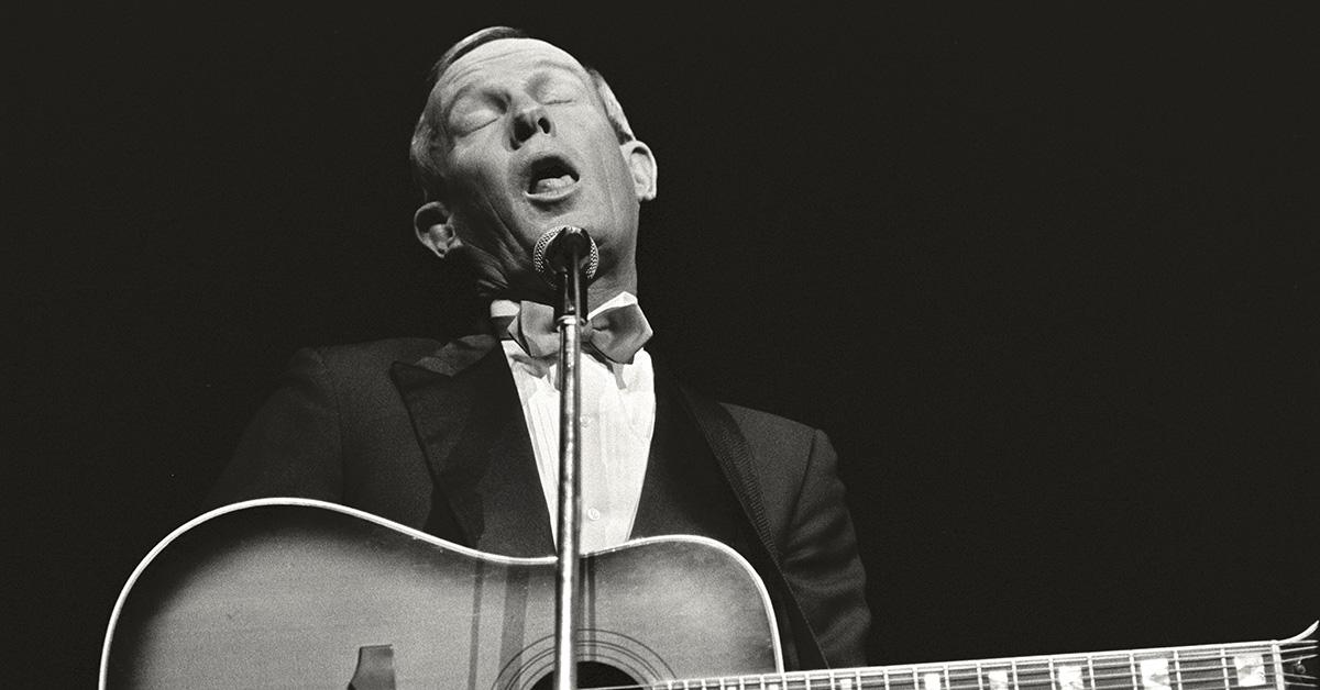 Tom Smothers performing with a guitar in Cheyenne. 