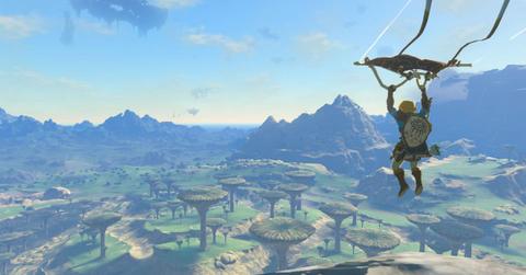 'Tears of the Kingdom' Link paragliding over Hyrule during daytime.