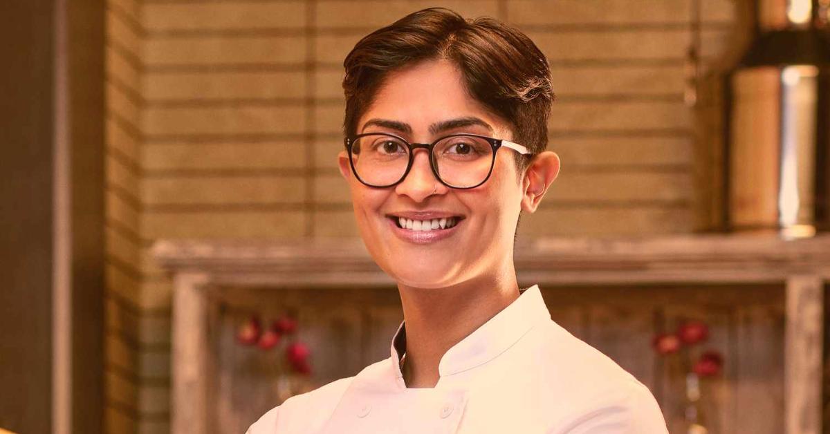 Rasika Venkatesa wears a white chef's jacket for her official 'Top Chef: Wisconsin' portrait.