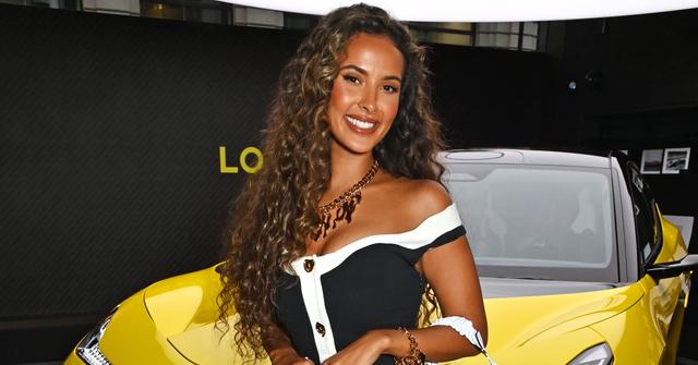 maya jama poses in front of yellow car