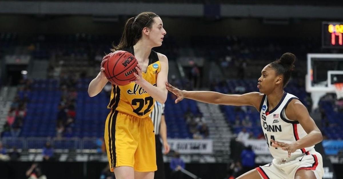 Caitlin Clark (L) faces off against an opposing team. 